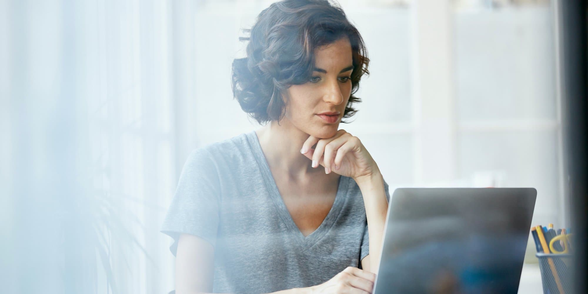 person reading off laptop at table