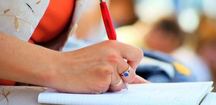 person writing in a notebook