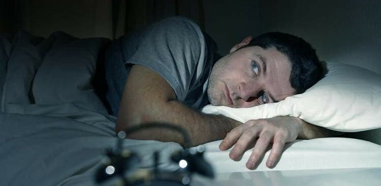 man having trouble sleeping