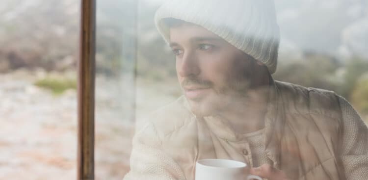 man looking out window