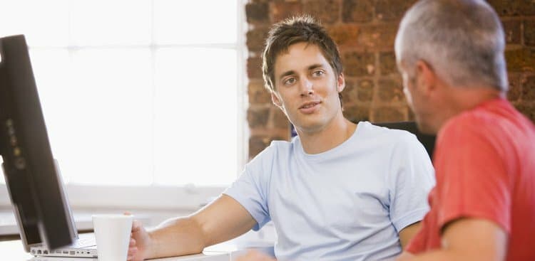 man apologizing to colleague