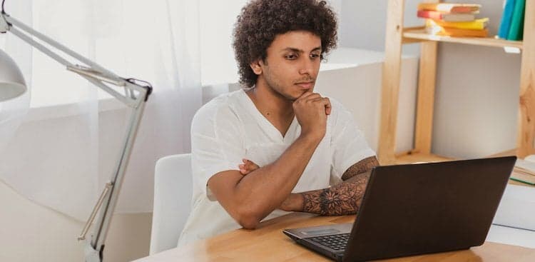 person thinking on computer