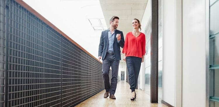 two co-workers walking