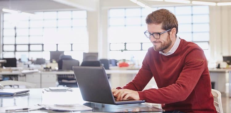 person in office on computer