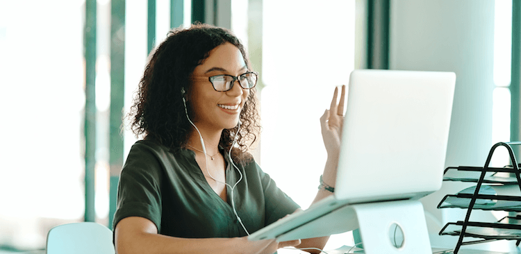 person sitting in front of a laptop using video chat