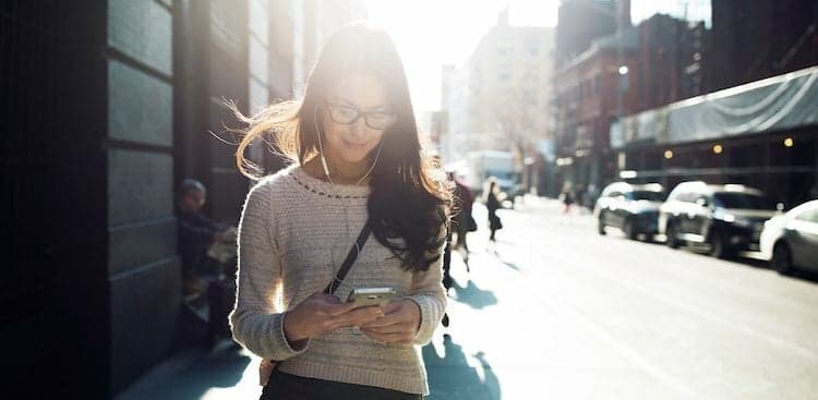 person looking at their phone outside