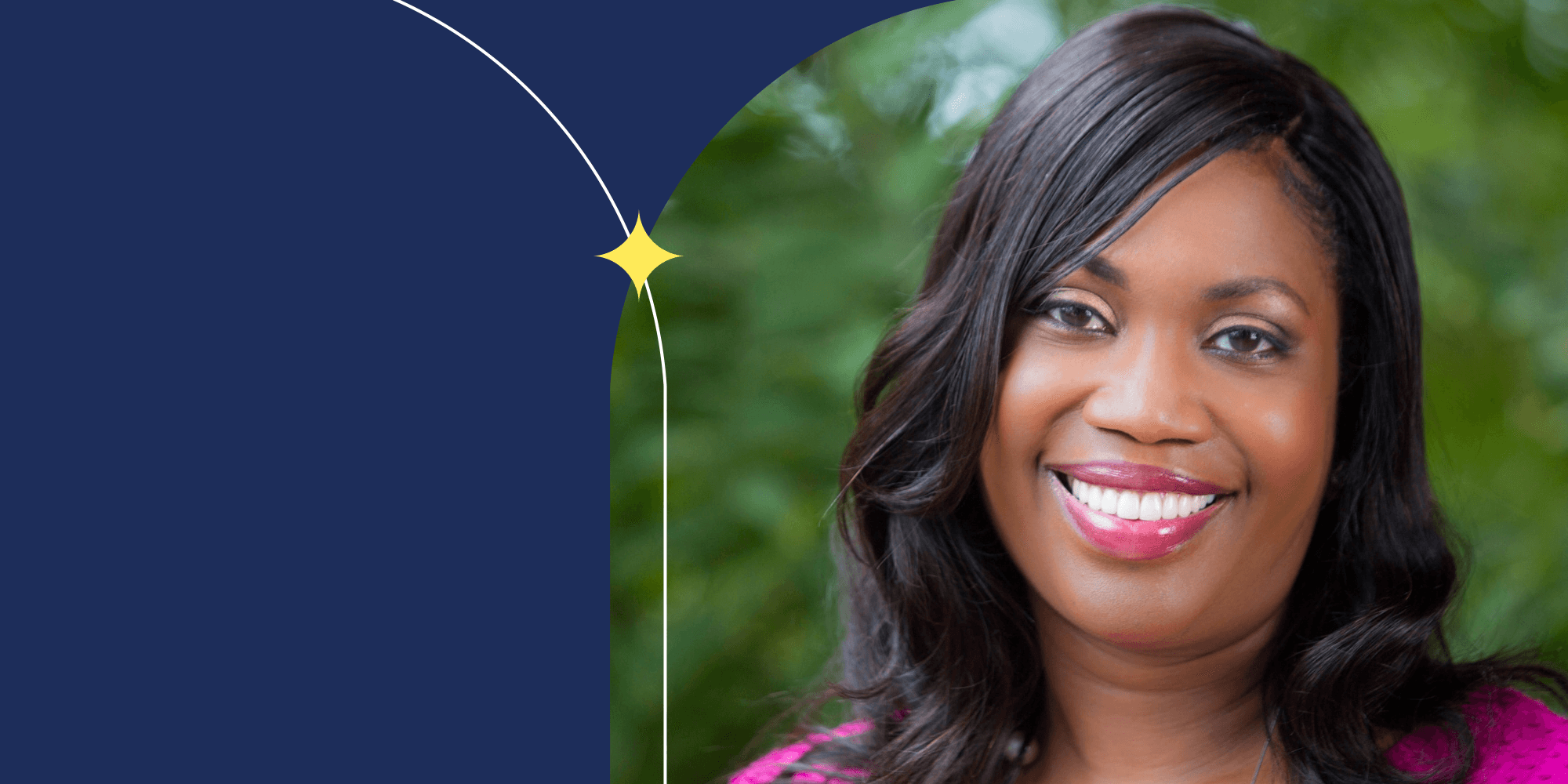 A smiling person facing the camera. They are wearing a pink shirt and pink lipstick.