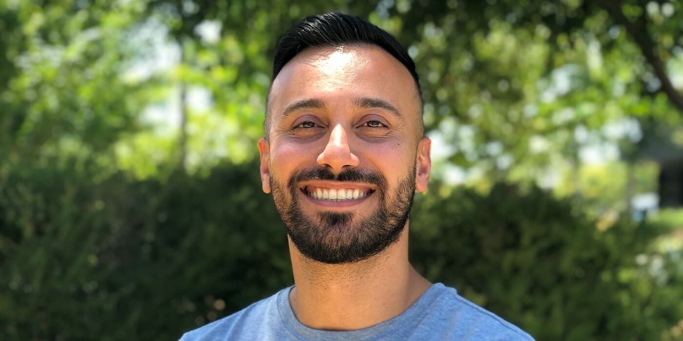 person with a beard smiling
