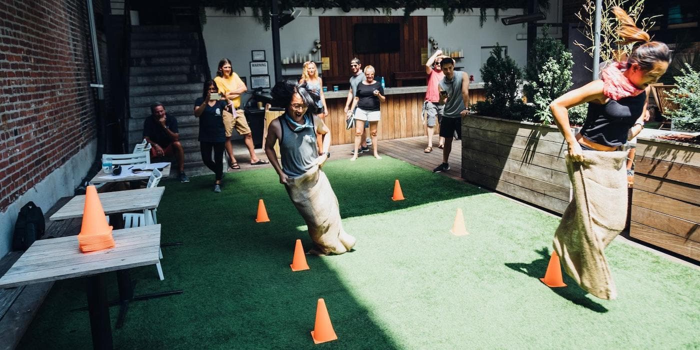 Cureatr employees participating in a potato sack race