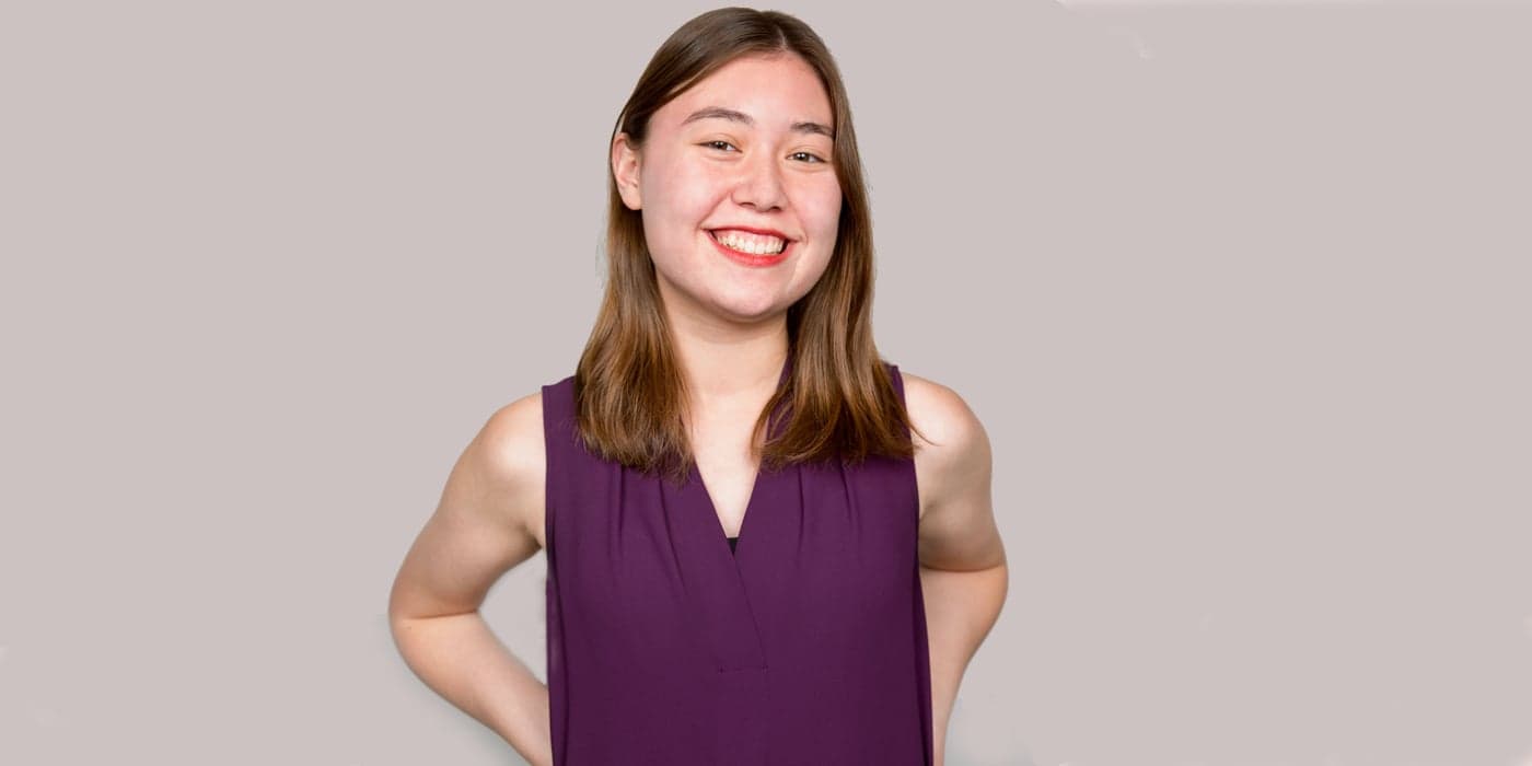person with shoulder-length hair smiling