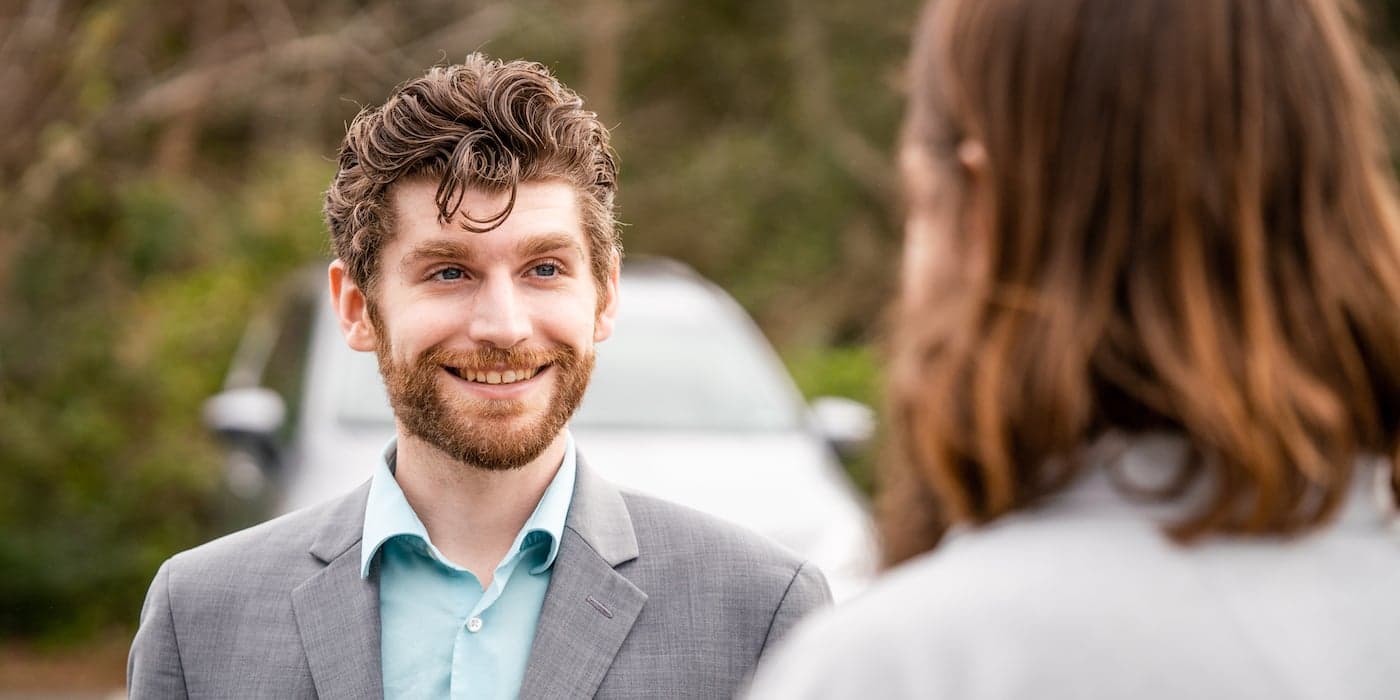 person with beard smiling at a customer