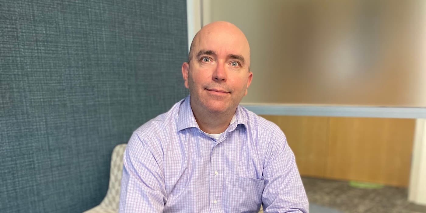 person wearing a button-down shirt sitting in an office