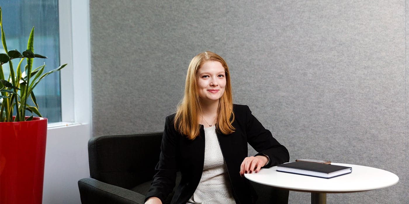 Person with long red hair sitting in an office