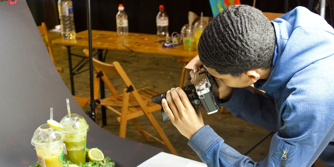 man taking a photograph of smoothies