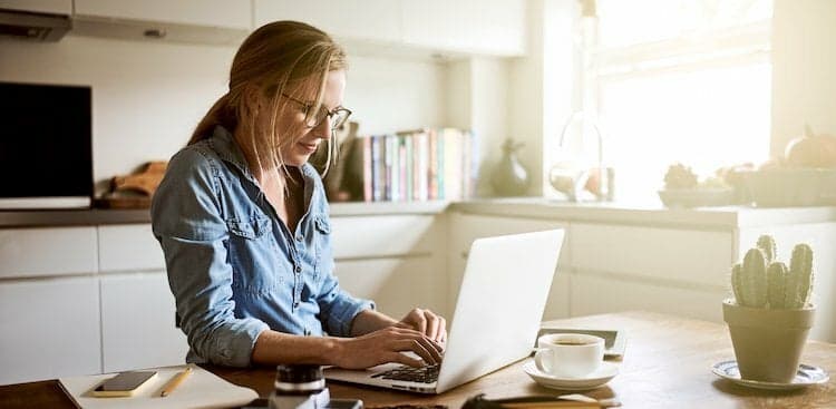 person on laptop in kitchen