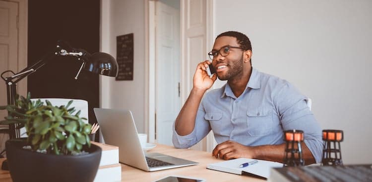 person smiling and talking on the phone