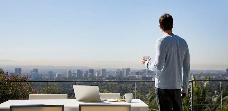 person outside with laptop nearby