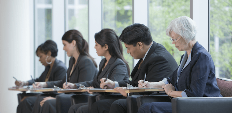 people of various ages filling out job applications