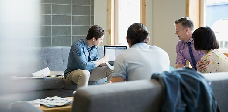 businessman with laptop leading meeting