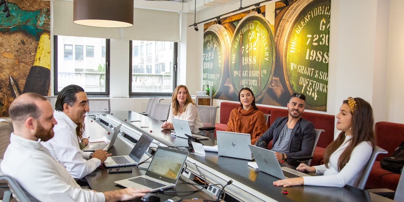 People sitting around a long conference room table.