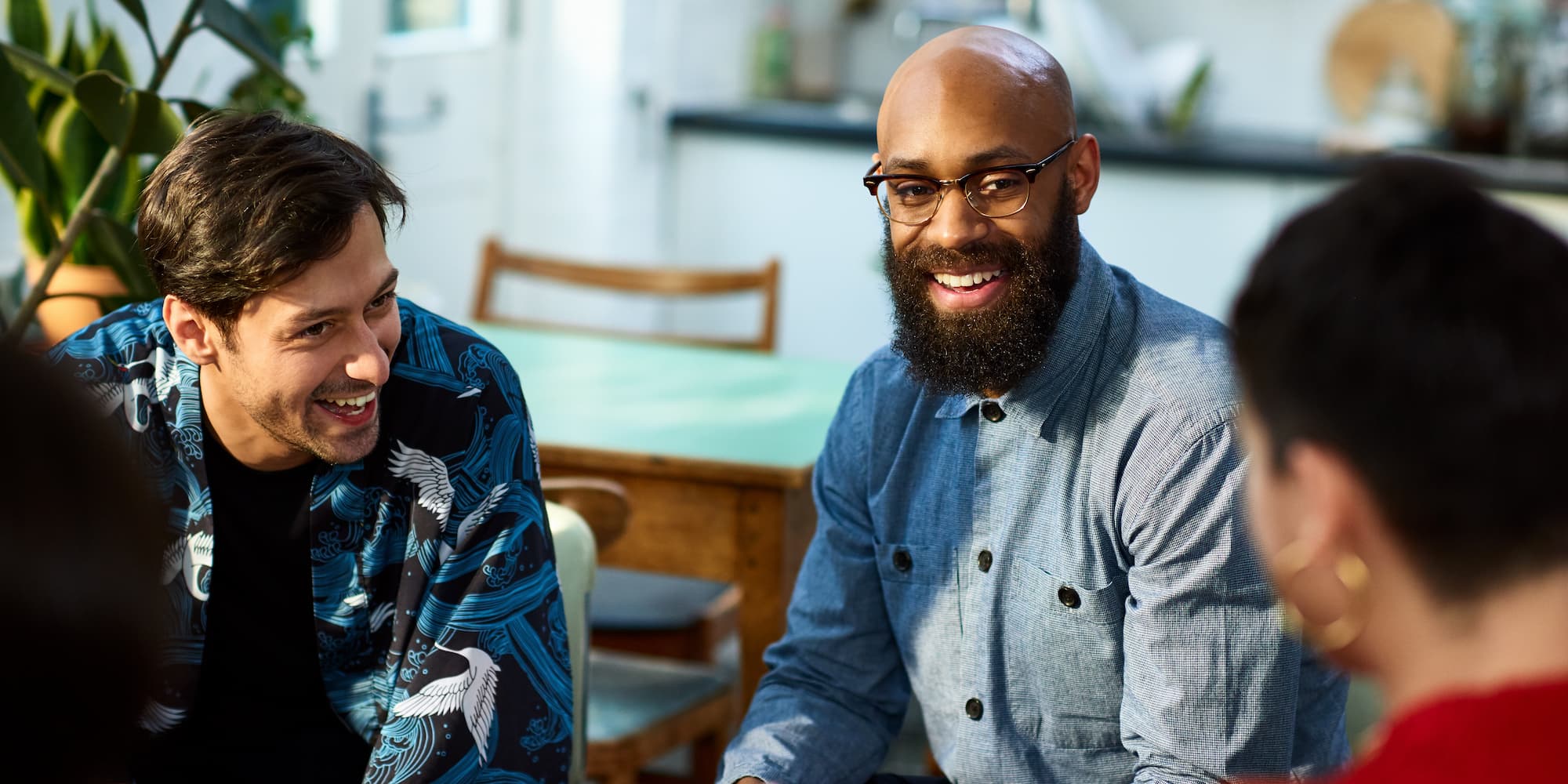 group of people talking and laughing in an office