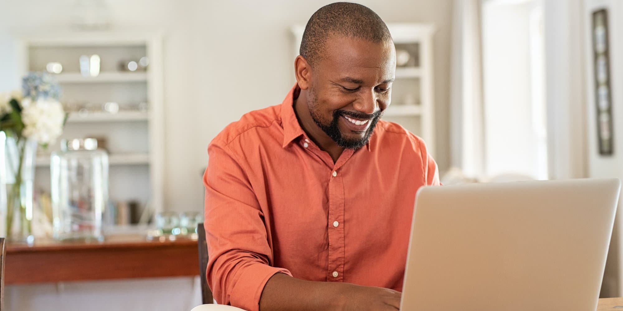 person sitting at counter working on laptop