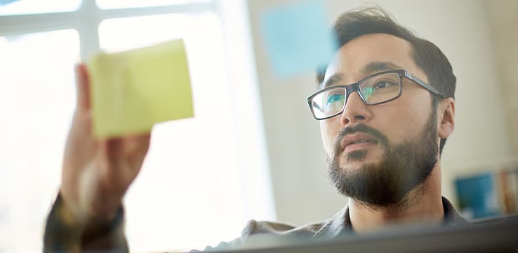 man looking at notes